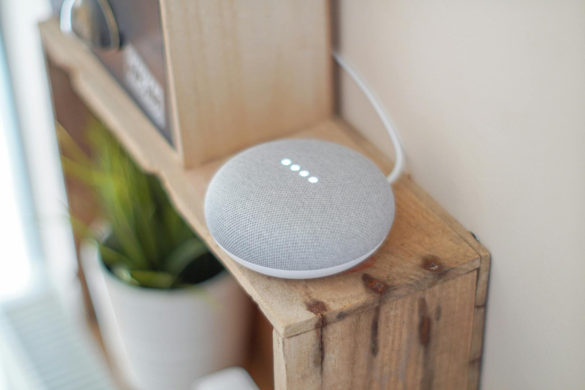 Modern smart home hub device on a wooden shelf