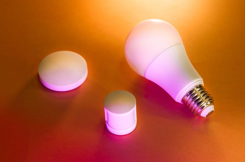 Smart light bulb glowing on a dark background